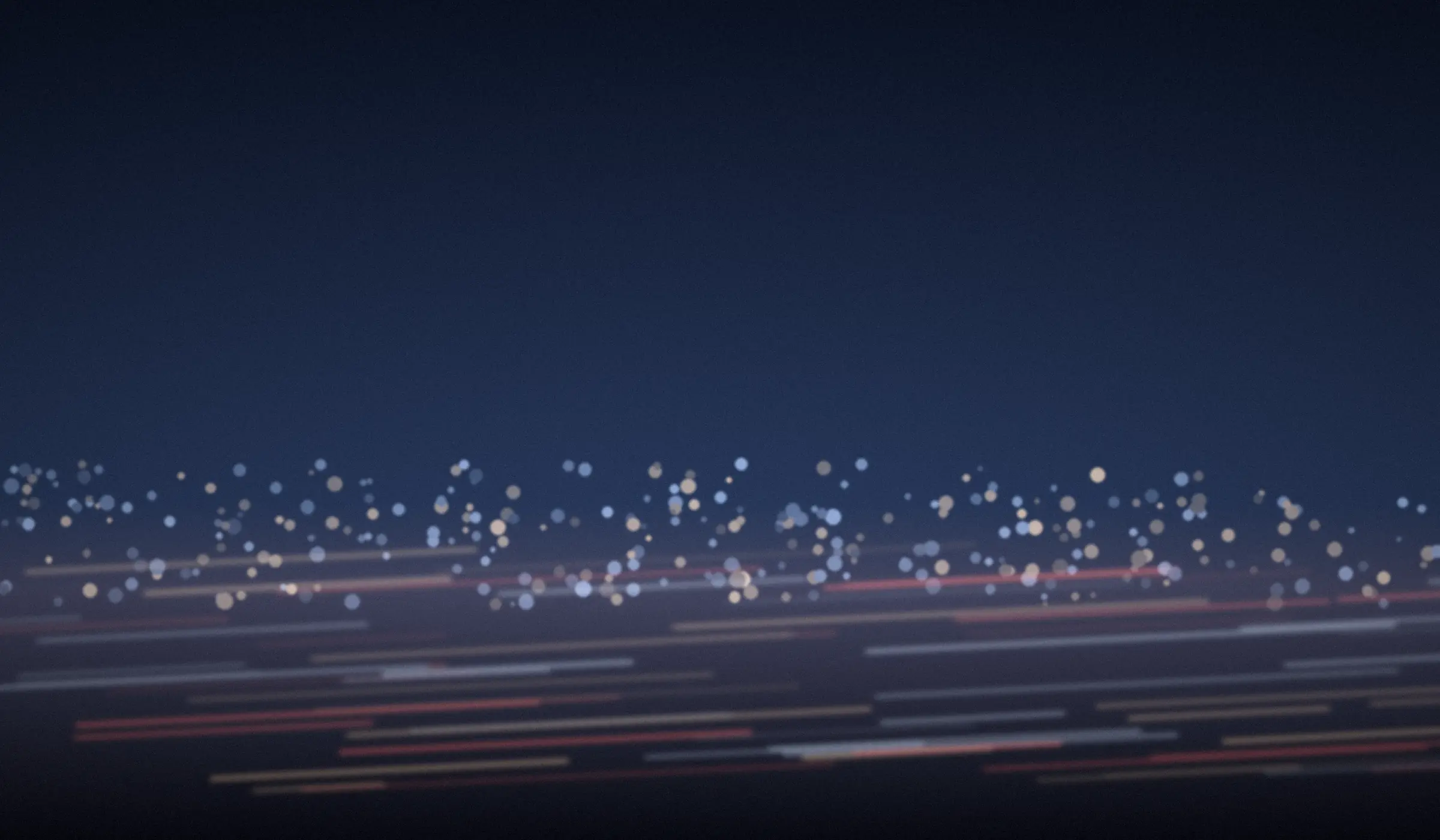 Blue-hour light trails across a city at night